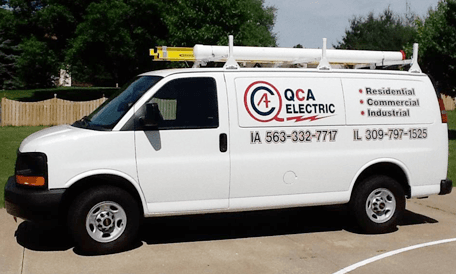 QCA Electric service van lettered with the company logo and both the Iowa and Illinois phone numbers